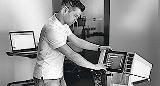 A service technician is explaining and showing features on Erbe workstation.