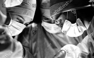 Surgeon team at work is operating in hospital.